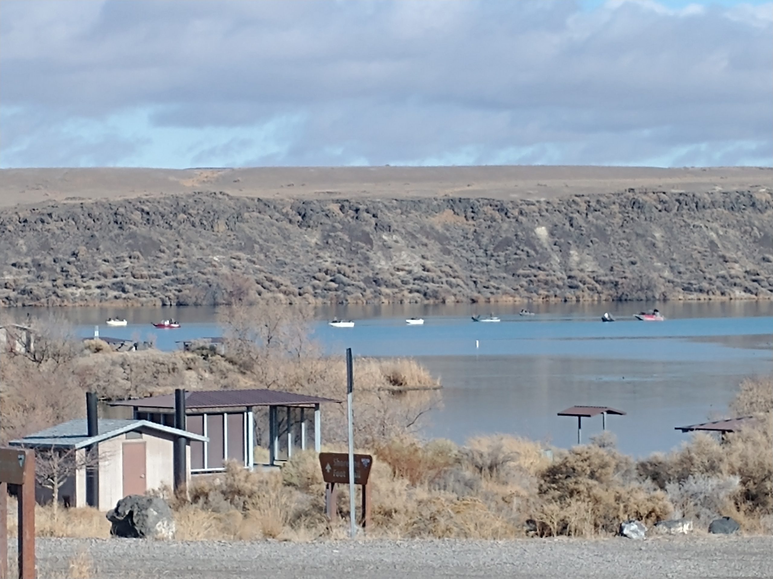 campground at cj strike with the lake in the background and fishing boats on the lake